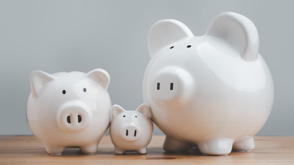 3 piggy banks on table