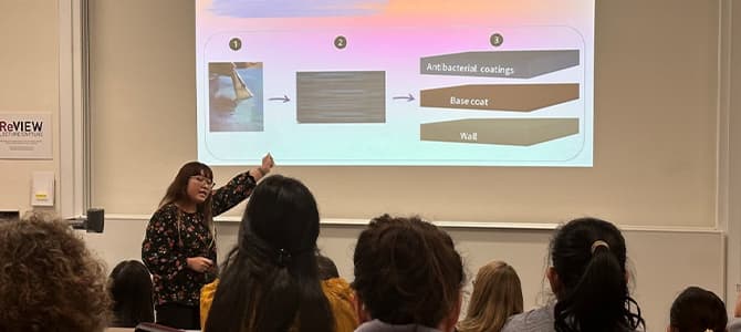 phd researcher giving a talk about research in a lecture theatre