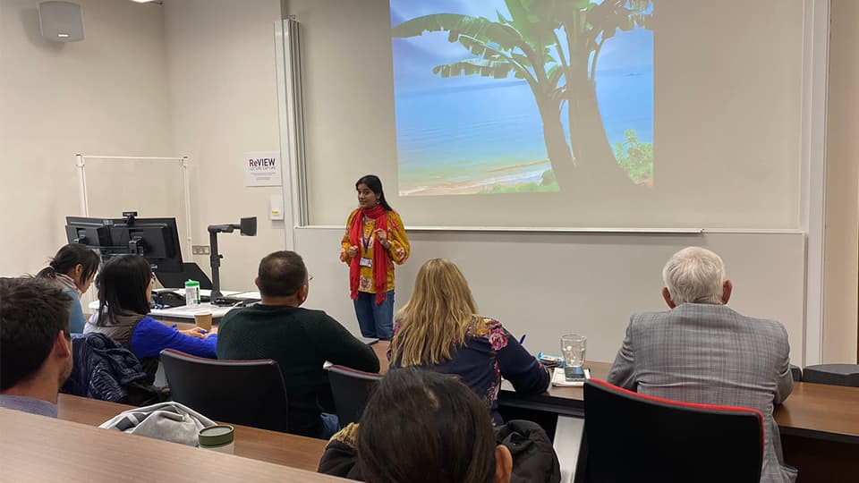 research student delivering presentation in lecture hall