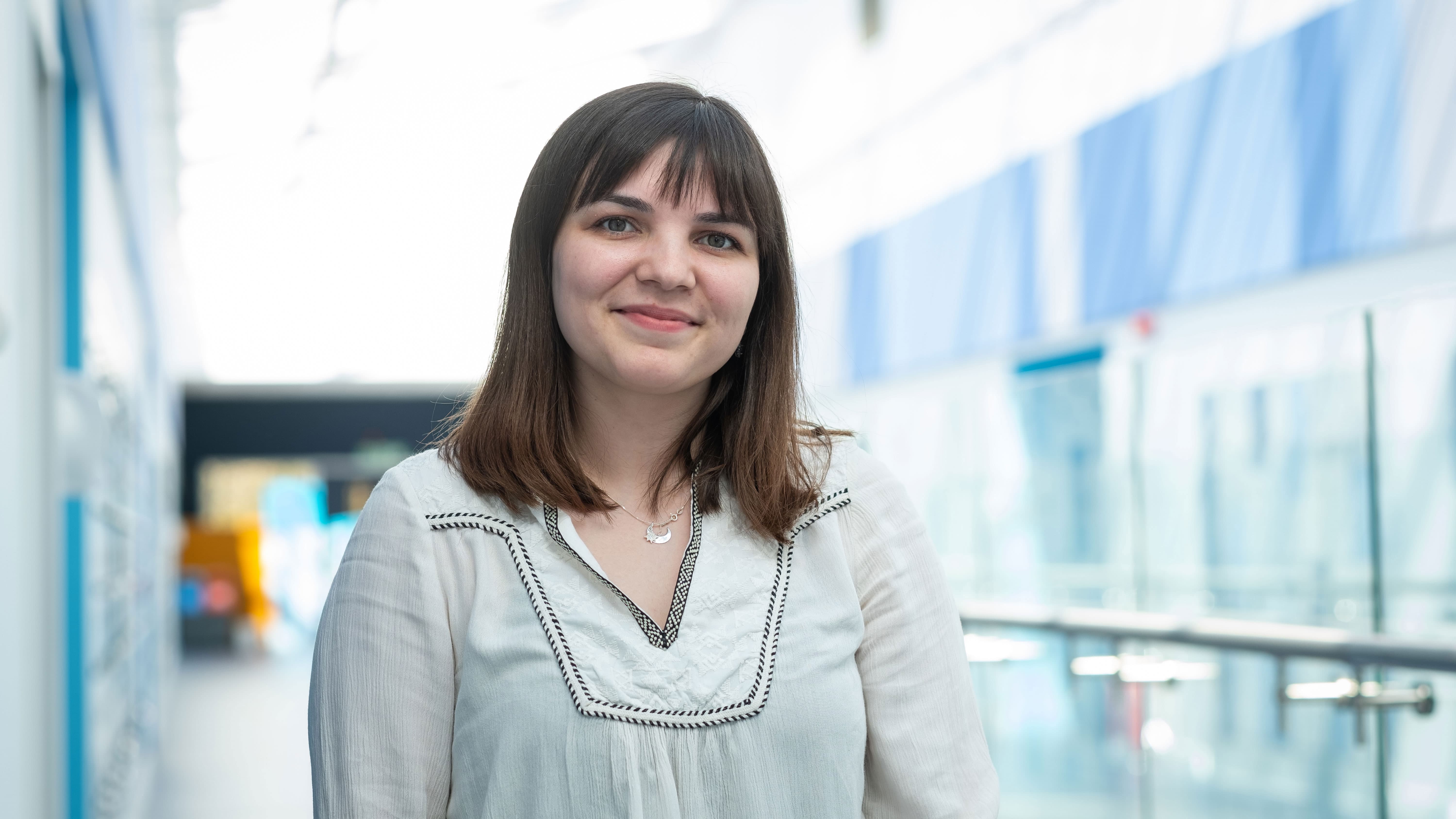 Master's student Melis in the main corridor of the STEMLab facility