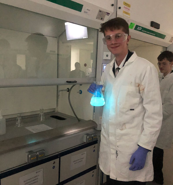 a pupil holding a lab flask