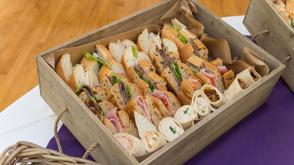 A box filled with a variety of sandwiches