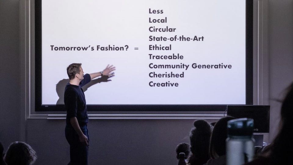 Patrick Grant with presentation slide: Tomorrow's Fashion? = Less, Local, Circular, State-of-the-Art, Ethical, Traceable, Community Generative, Cherished, Creative.