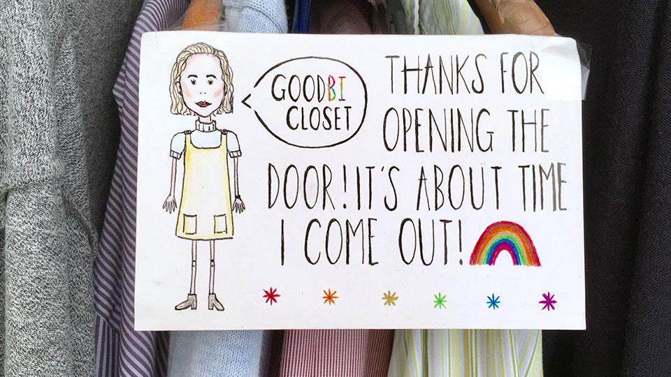Photos of clothes hanging up with a poster in front, 'GoodBI Closet. Thanks for opening the Door! It's about time I come out!