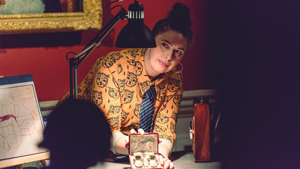 Student under a low lit desk lamp showcasing jewellery