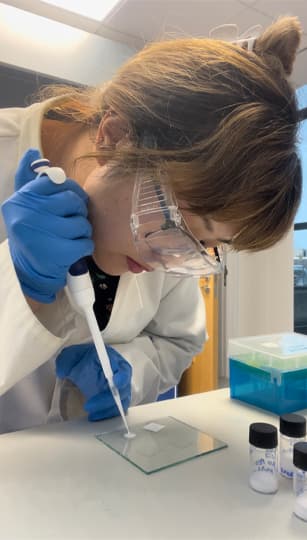 research student using a pipette