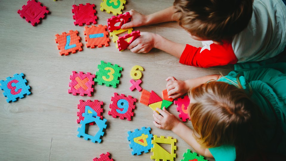 Kids playing with numbers on mat