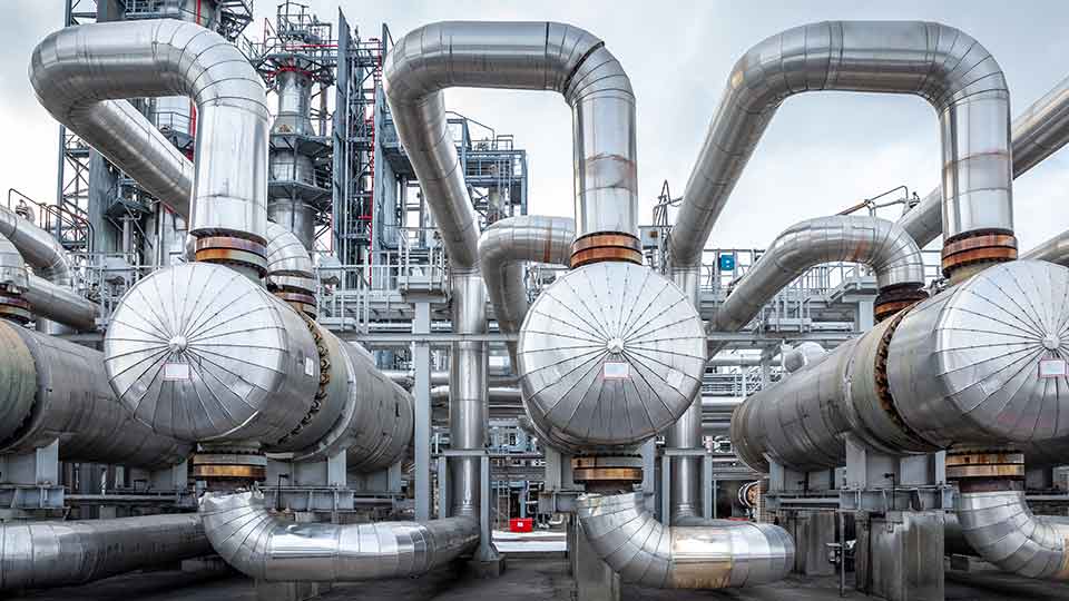 A heat exchanger in an oil refinery, large size, shot in daylight.