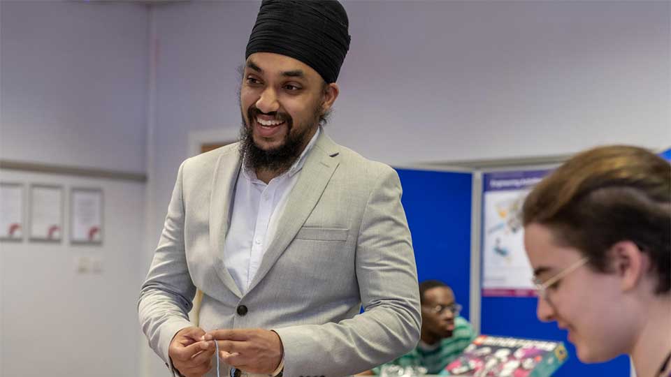 Action shot of a male student smiling, looking away from the camera.