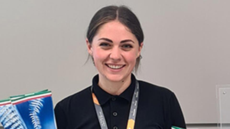 Headshot of Product Design Engineering graduate Abigail smiling, wearing a black polo shirt.