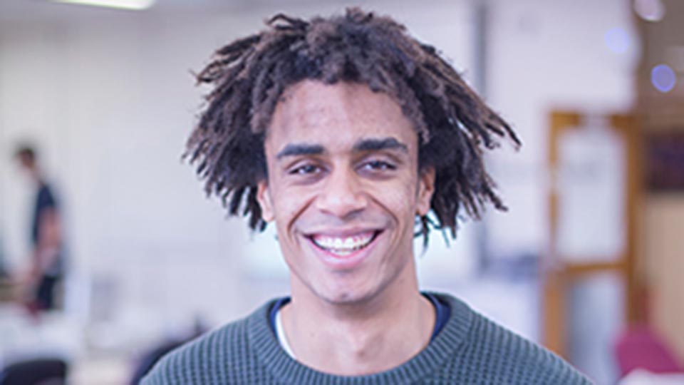 Headshot of student Josh, smiling, looking directly at the camera. 