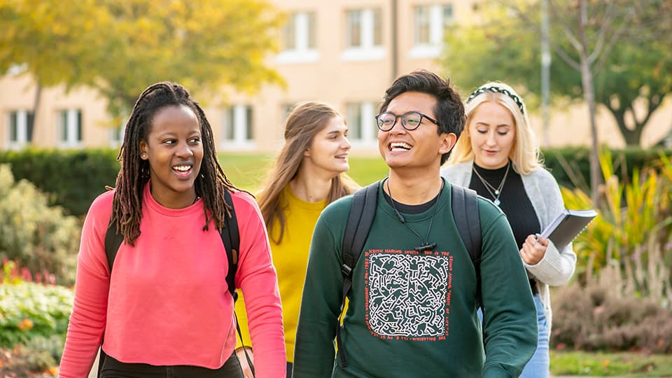 Two people walking together and smiling