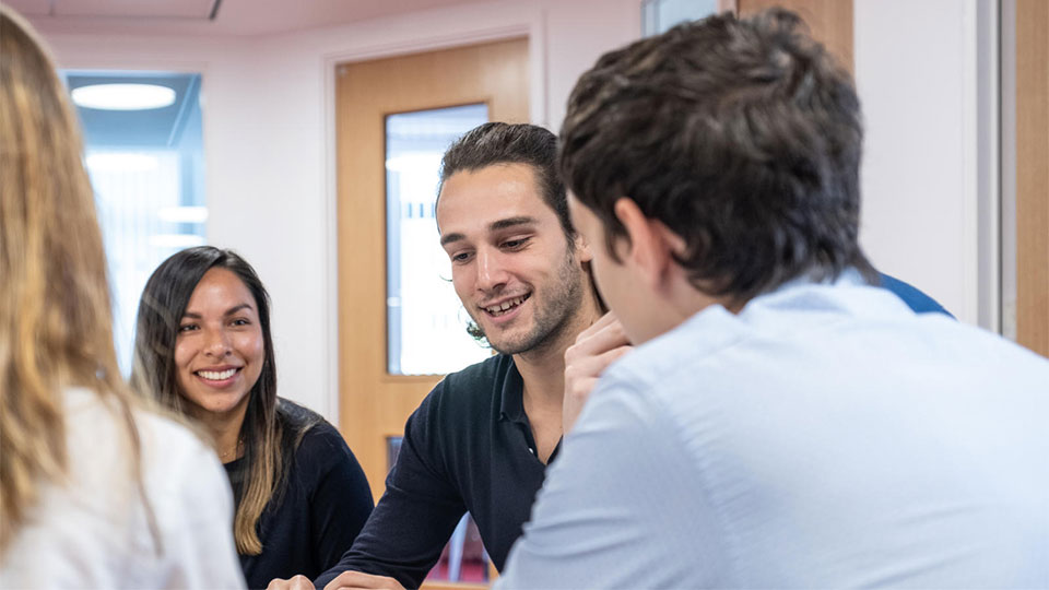 A male and a female student laughing together.