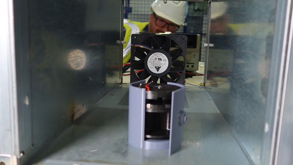 A close up of a wireless sensor node powered by a miniature wind turbine.