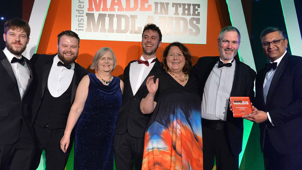 Winners standing together holding awards at the Made in the Midlands Award ceremony. 