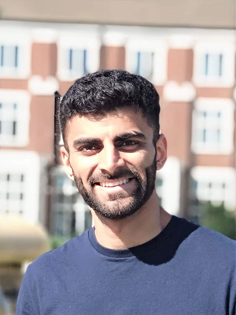 Portrait headshot of Hamza stood outside.