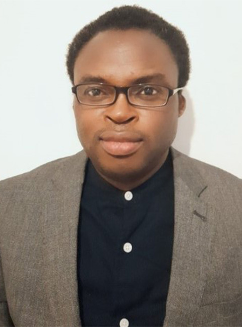 Headshot of Chukwuma, looking directly at the camera