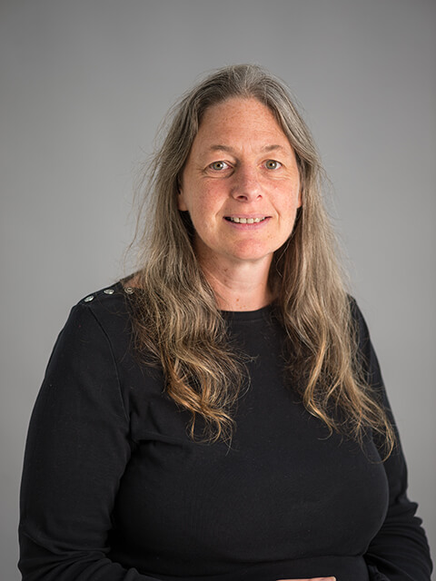 Headshot of Dani, smiling whilst looking directly at the camera