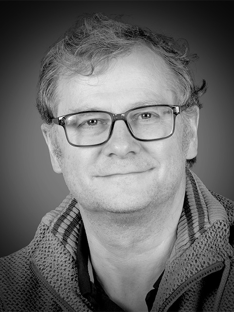 headshot of Michael Wilkinson in black and white