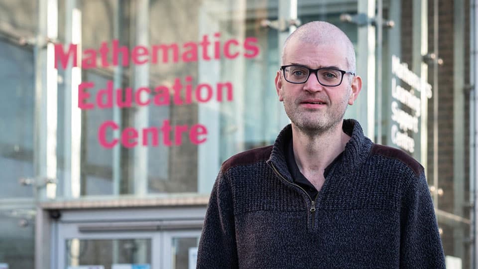 Matthew Inglis standing outside the Mathematics Education Centre.