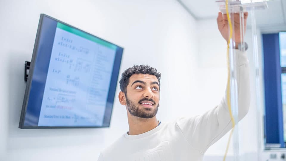 A student in the Physics department conducting an experiment.