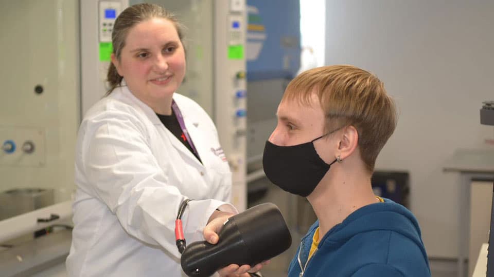 Sarah Bugby using a hybrid gamma camera to examine a patient's neck.