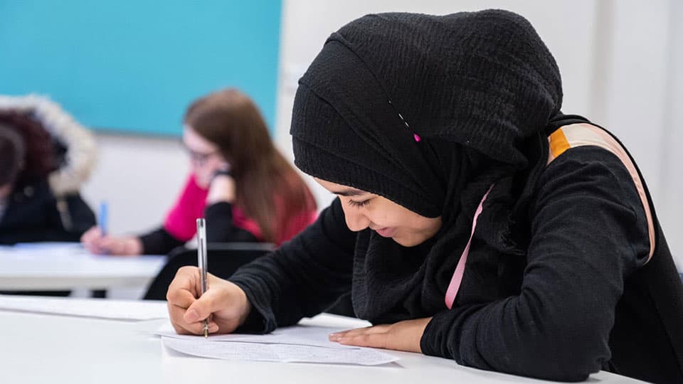 A schoolchild writing