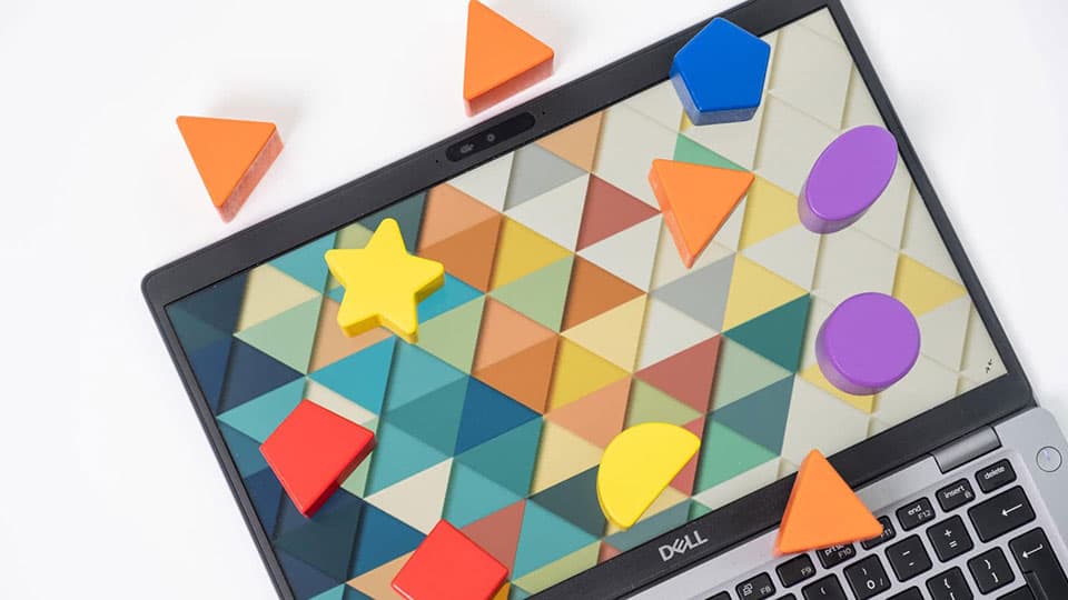 A laptop screen covered in physical mathematical shapes