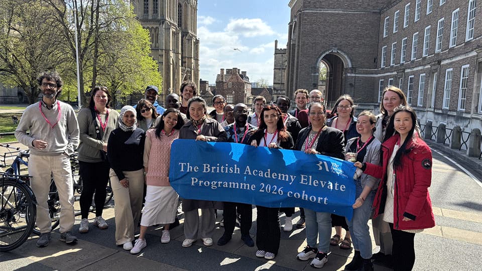 The group of programme participants holding a banner which says 'The British Academy Elevate Programme 2026 cohort'