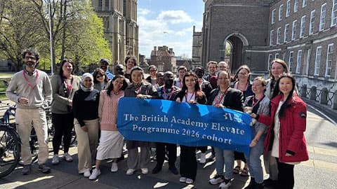 The group of programme participants holding a banner which says 'The British Academy Elevate Programme 2026 cohort'
