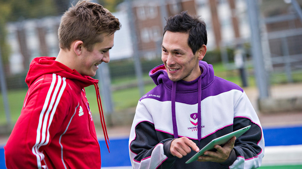 Coach using tablet to provide advice to an athlete