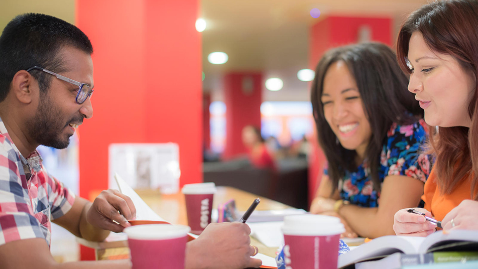 PGR students chatting over coffee