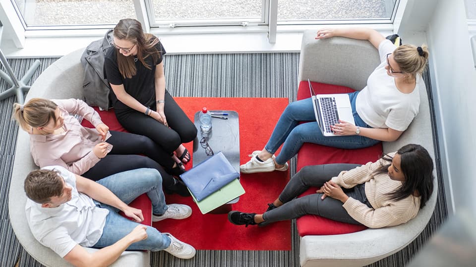 Students talking in a breakout space