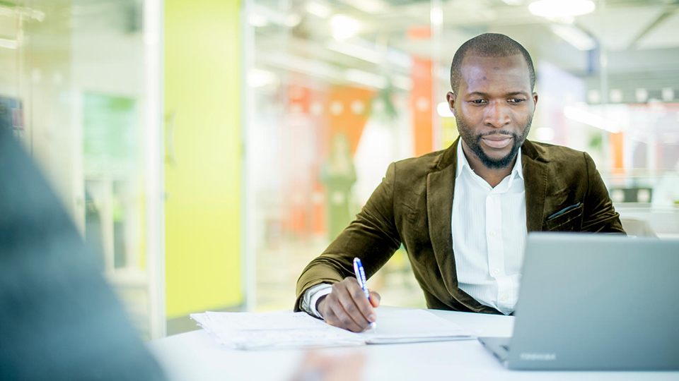 Student working on laptop in business dress