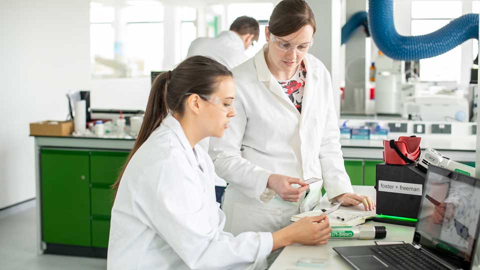 Two female students working in a lab