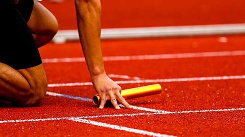 An athlete at the start of a relay race