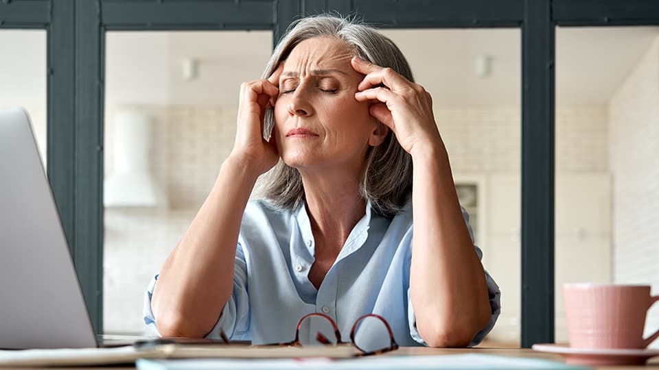 A woman holding her head