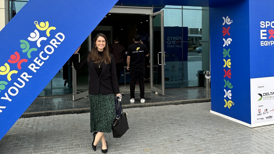 female academic standing outside conference centre