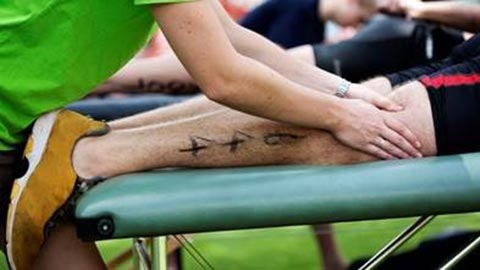 Sport massage being administered on person's leg