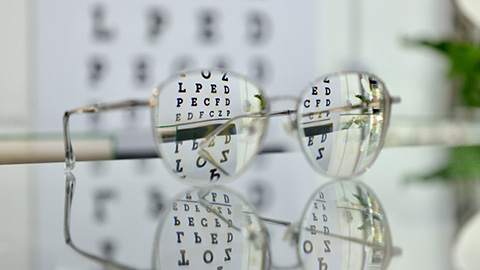 Glasses in front of a reading chart. Image provided by Getty