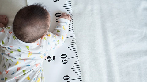 Baby lying on their tummy. Image from: Getty