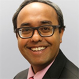 A headshot of Winston Rennie wearing glasses