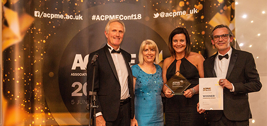 Group of people holding the award