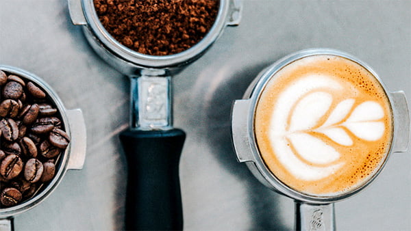 Coffee beans, ground coffee and a cup of coffee.