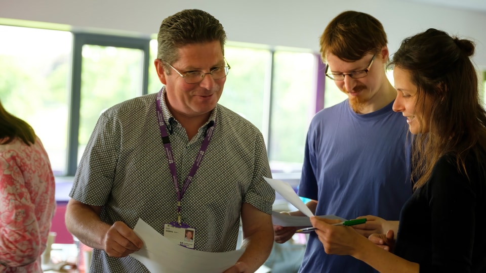 Three members of staff stood in discussion