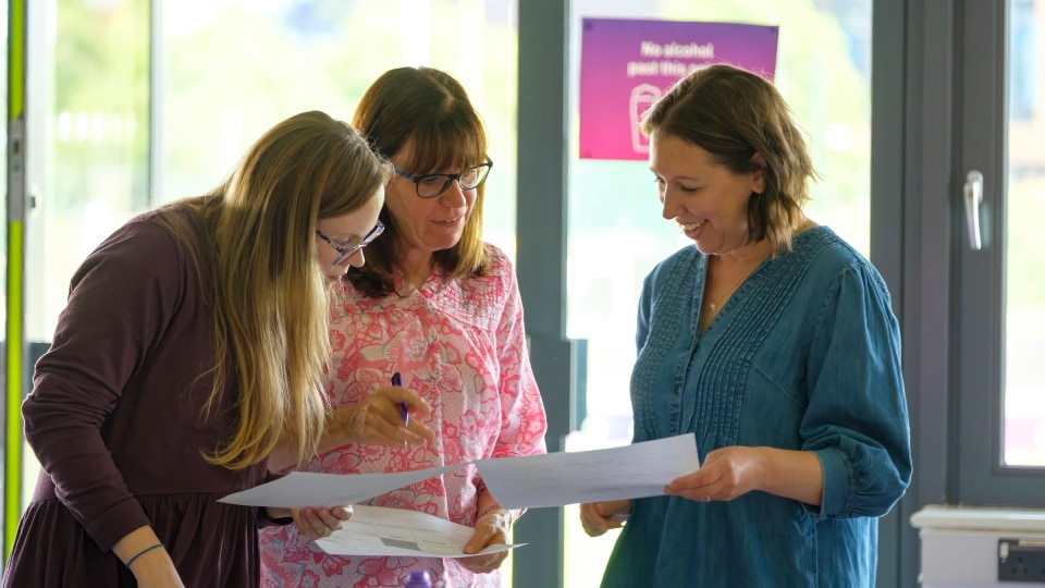 Three members of staff stood in discussion