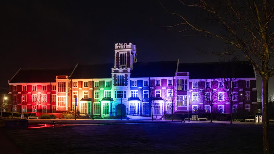 the Hazlerigg building illuminated with rainbow lights