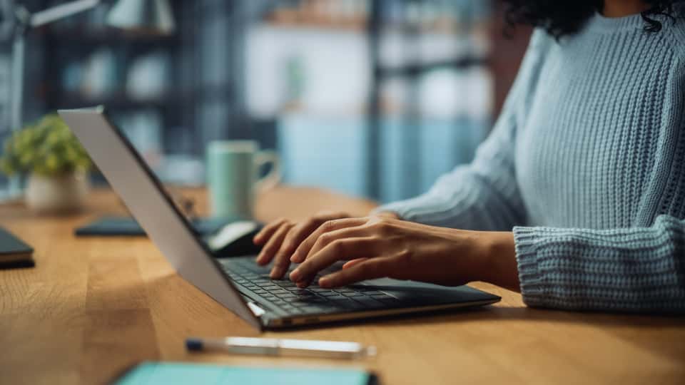 A student typing on a laptop