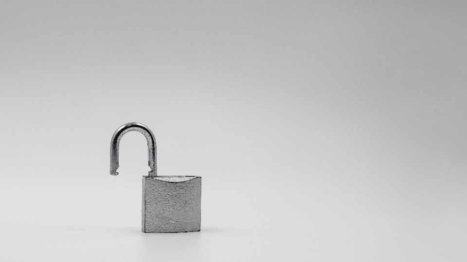 An open silver padlock on a grey background