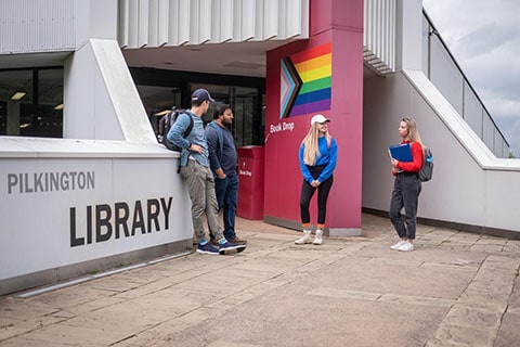 Library front door with students chatting outside